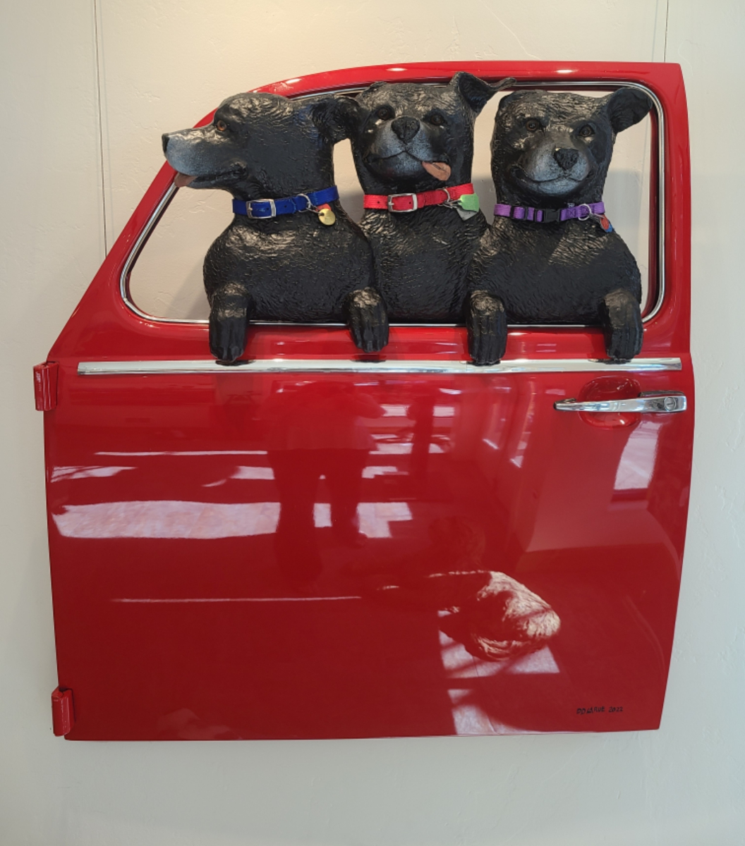 3 Black Labs in a Red VW Door